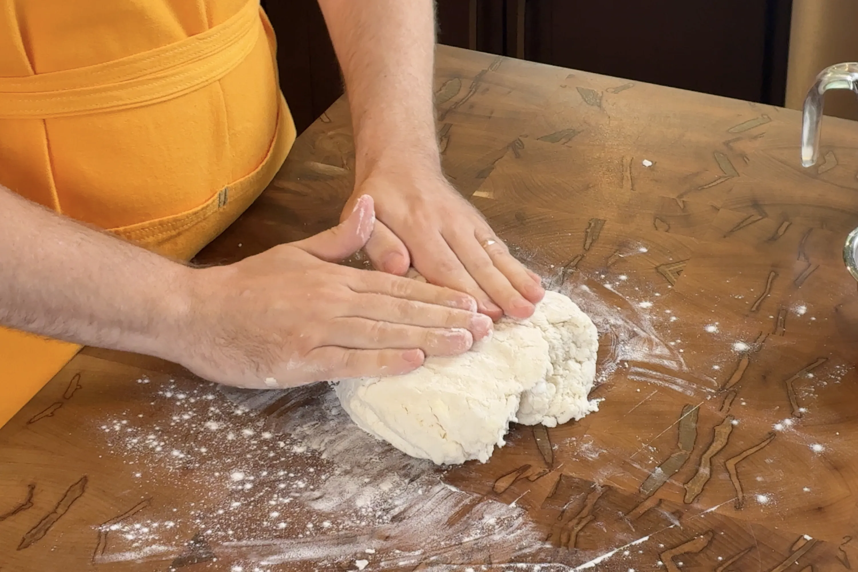 Using our hands to press out and shape our biscuit dough