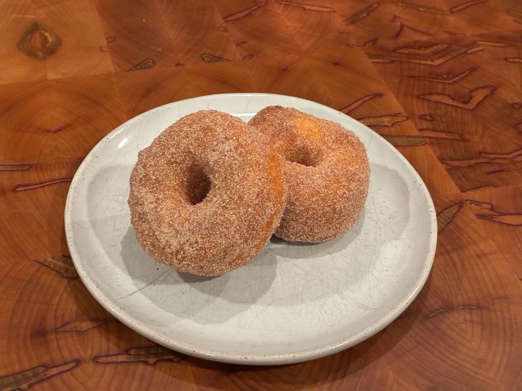 Three cinnamon donuts on a plate
