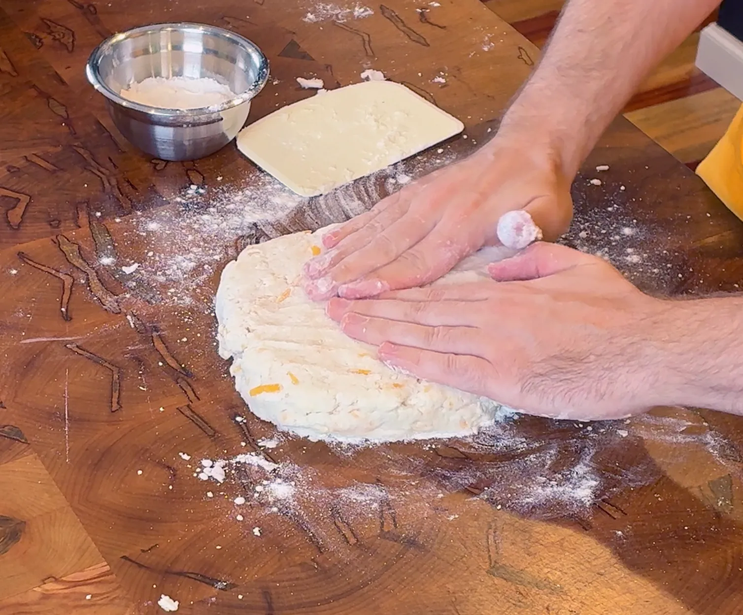 Using our hands to press out and shape our biscuit dough